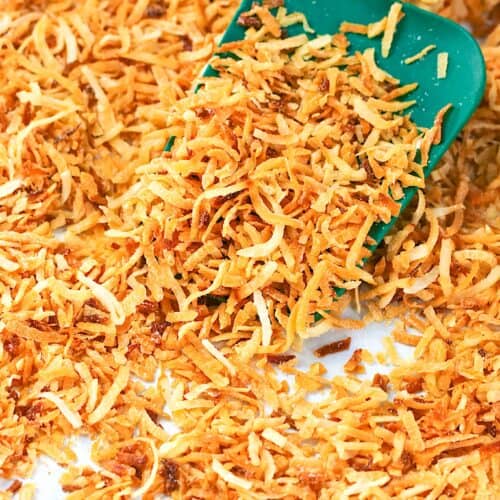 Transferring the toasty goodness from the baking sheet to a bowl to cool