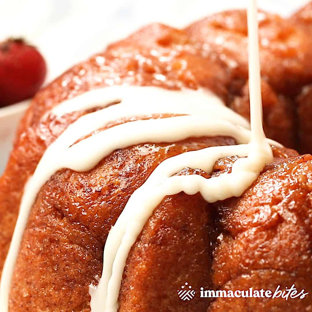 Drizzling the freshly baked cinnamon bread with a decadent glaze.