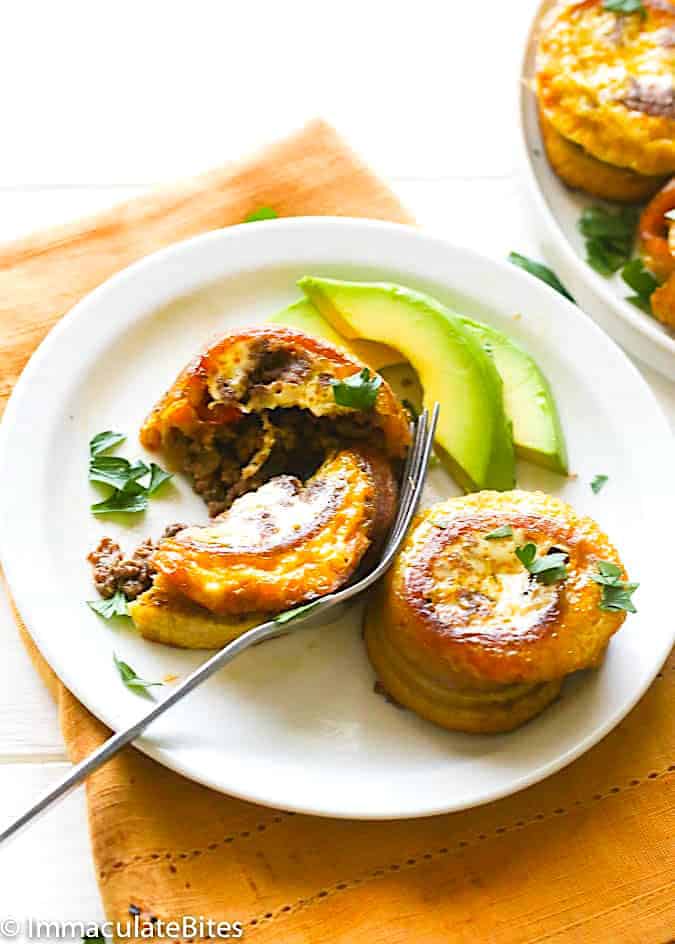 Cutting into a savory stuffed plantain with a fork.