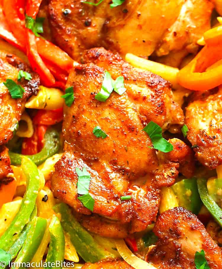 Penne pasta topped with jerk chicken and colorful bell peppers.