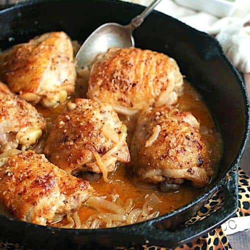Yassa chicken fresh from the skillet ready to serve over rice.
