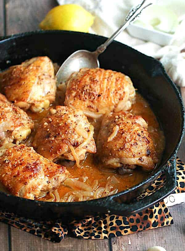 Yassa chicken fresh from the skillet ready to serve over rice.