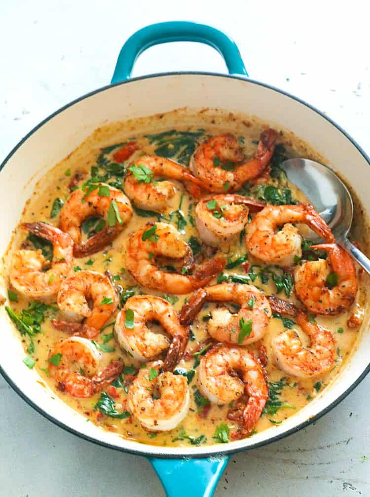 Juicy shrimp smothered in a creamy Tuscan sauce and ready to serve.