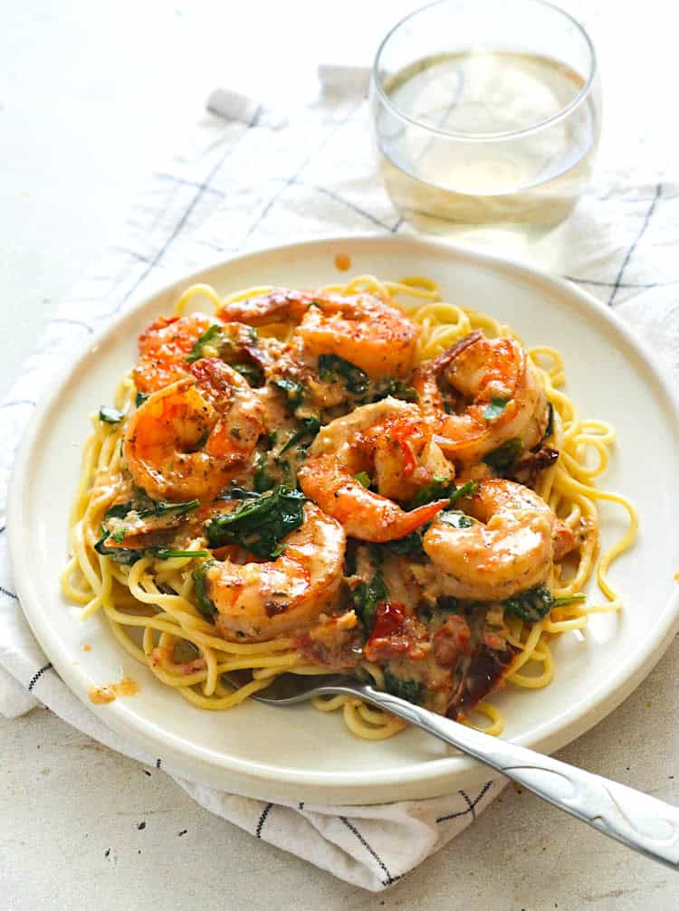 Plating up creamy shrimp over pasta for a quick and easy midweek dinner.