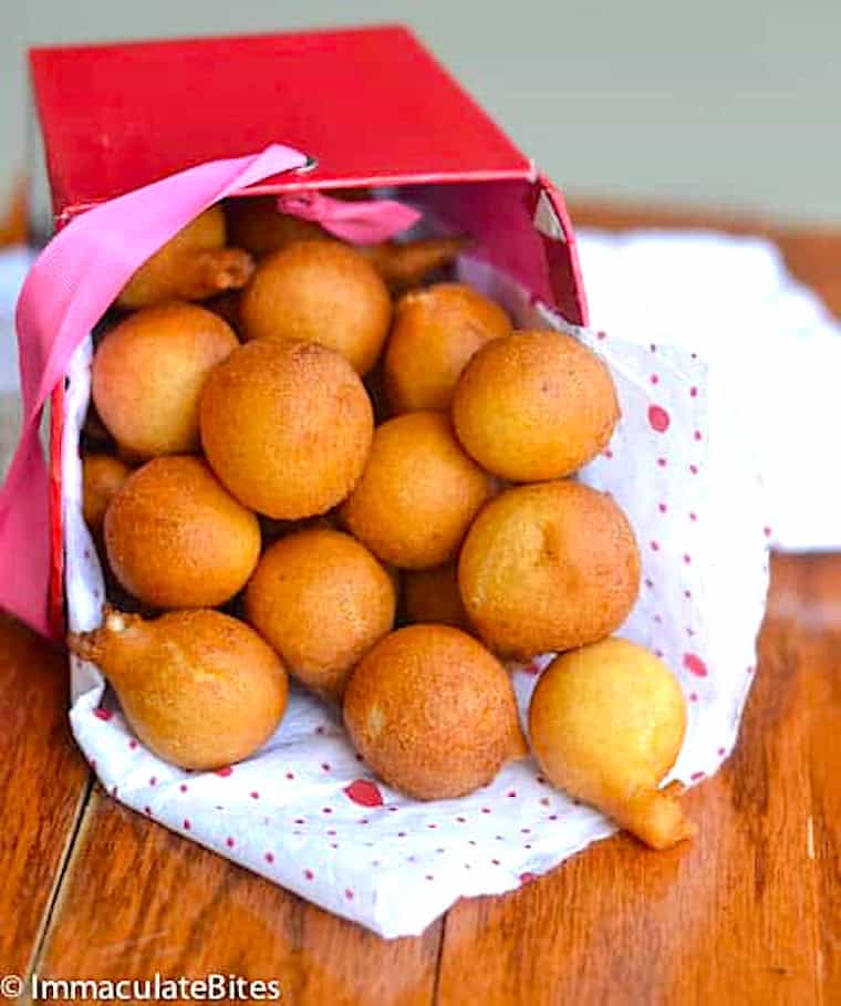 Enjoying a basket full of African doughnuts (drop doughnuts) for a fast sweet tooth fix.