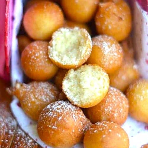 African drop donuts dusted with powdered sugar.