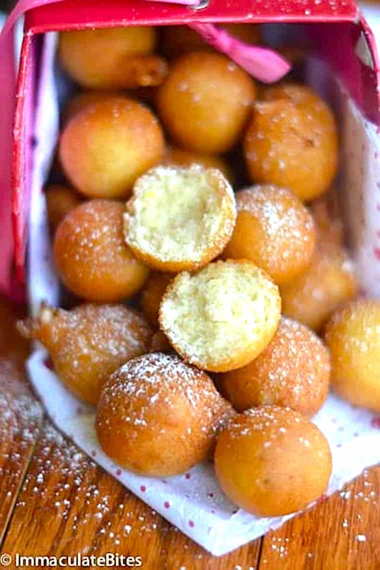 African drop donuts dusted with powdered sugar.