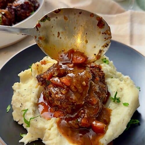 Serving braised oxtails with creamy mashed potatoes.