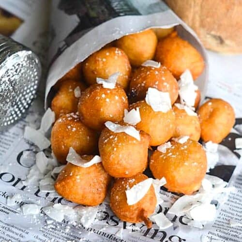 A newspaper cone filled with soul-satisfying coconut puff puff.