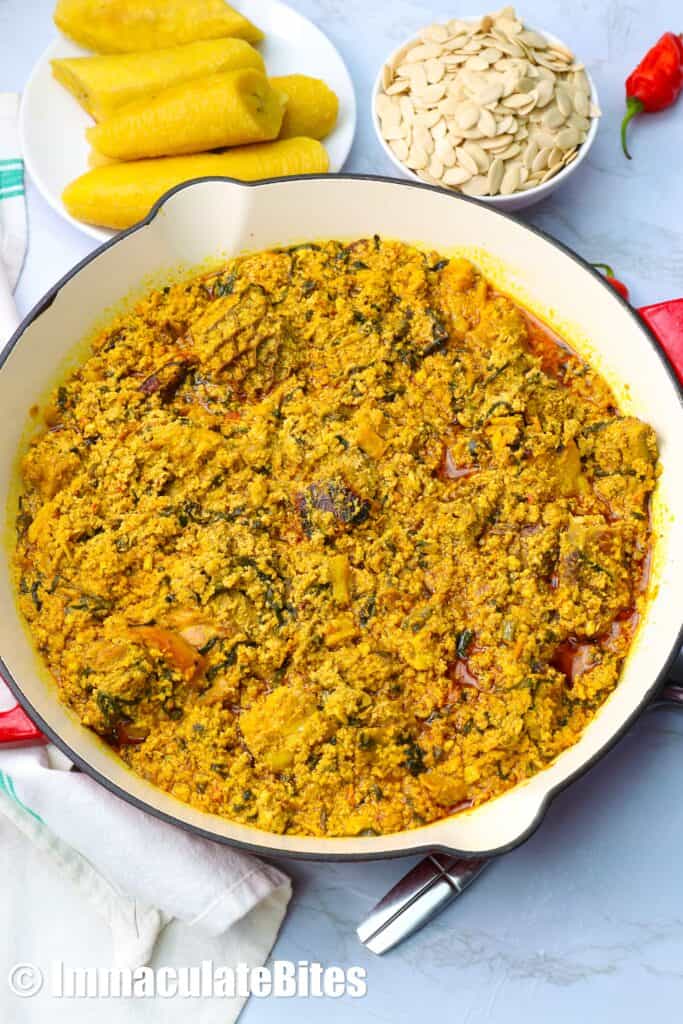 Enjoying egusi soup with boiled plantains.