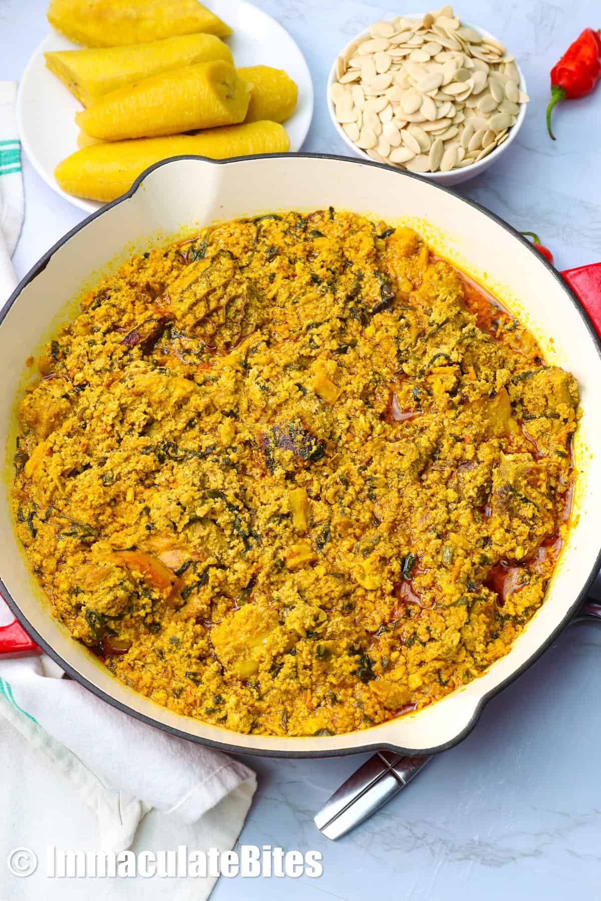 Enjoying egusi soup with boiled plantains.