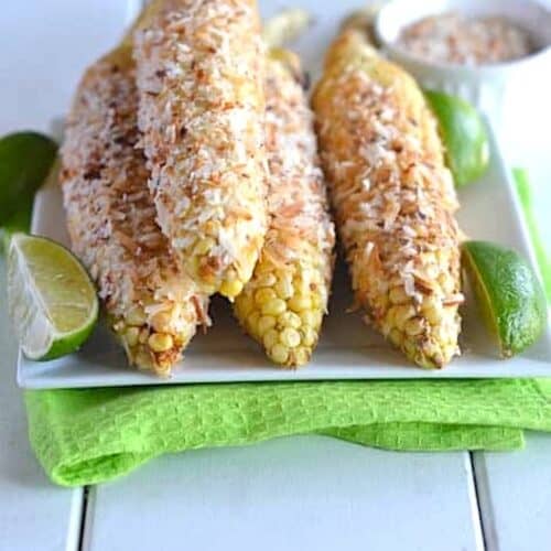 Corn on the cob fresh off the grill and covered in toasted coconut for a tropical treat.