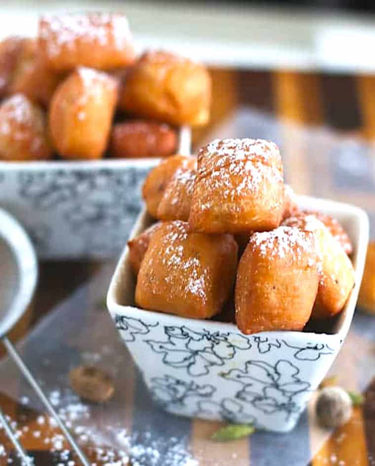 Fresh East African doughnuts sprinkled with powdered sugar.