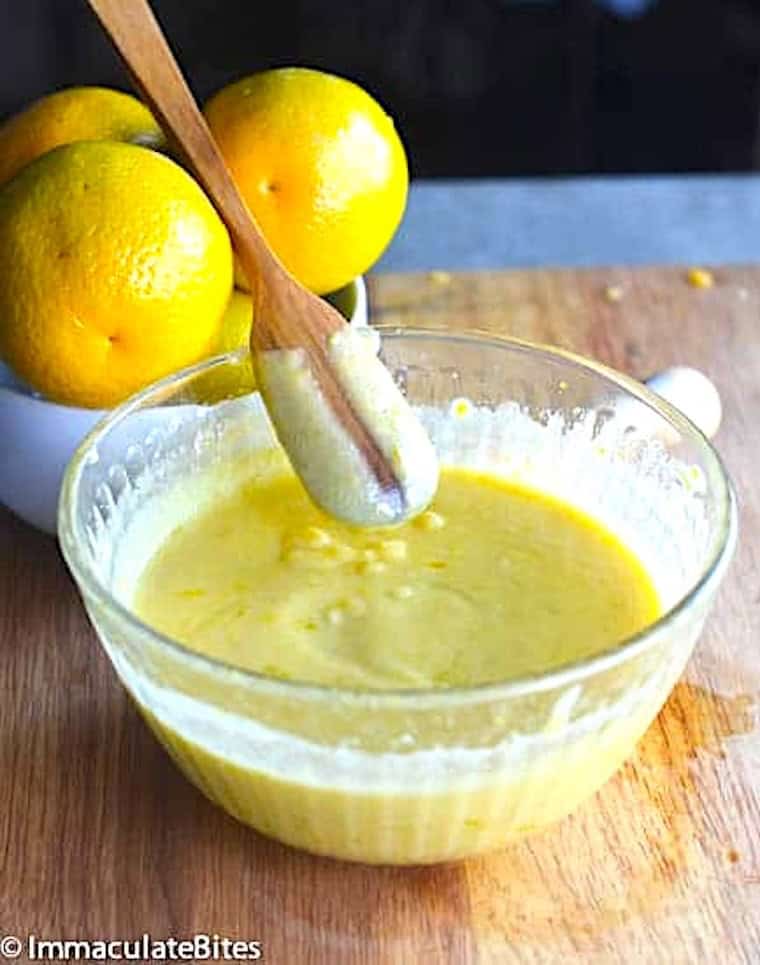 Fresh curd made with oranges coating the back of the spoon.