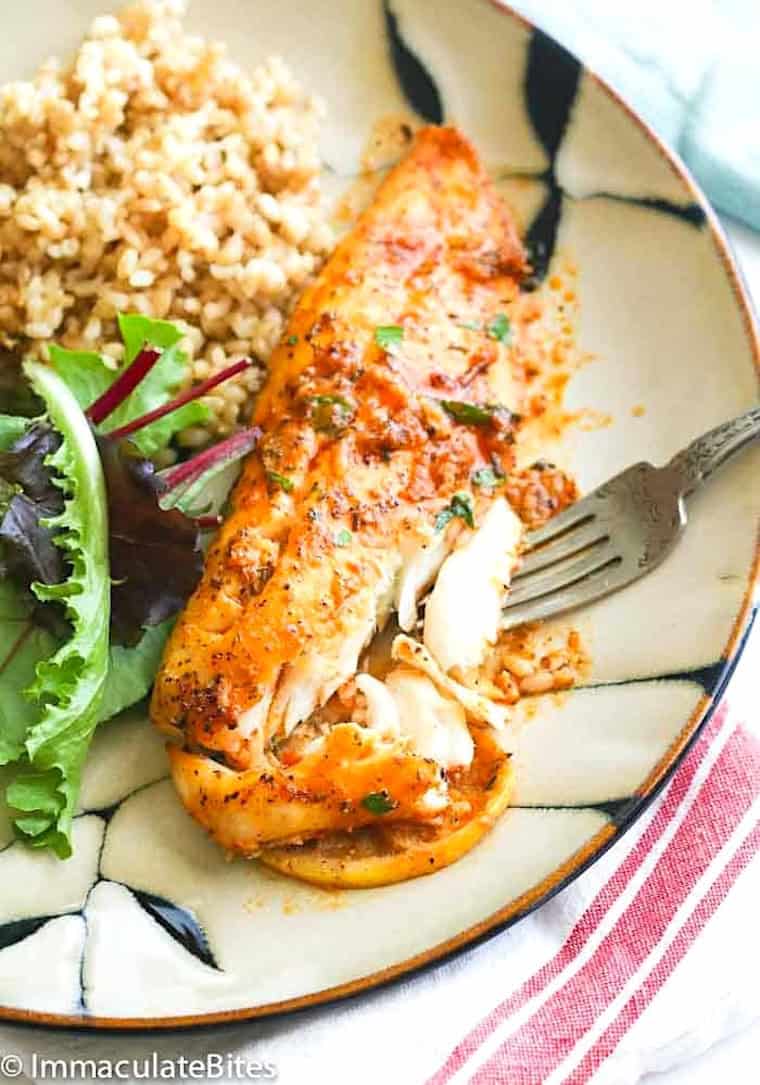 Forking into freshly baked fish with a baby greens salad and brown rice.