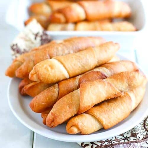 A stack of freshly fried African fish rolls on a plate and ready to share.