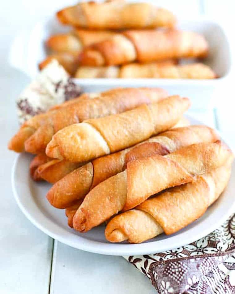 A stack of freshly fried African fish rolls on a plate and ready to share.