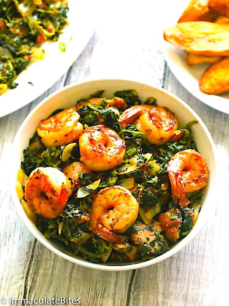 Finished stewed spinach ready to serve with boiled plantains (or fried).