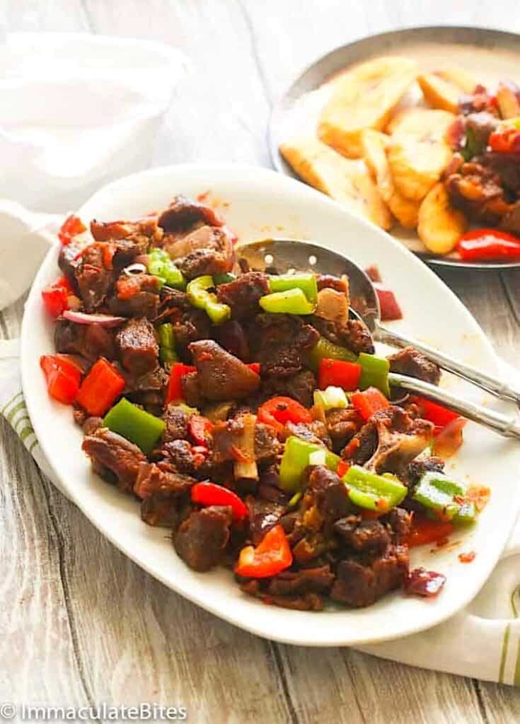 Serving up a platter of asun spicy roast goat for a special occasion.