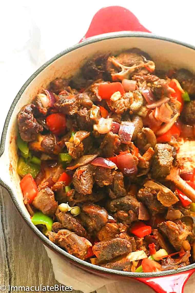 A skillet full of spicy smoked goat meat called asun in some parts of Africa.