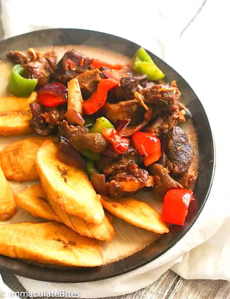 Serving up asun with fried sweet plantains.