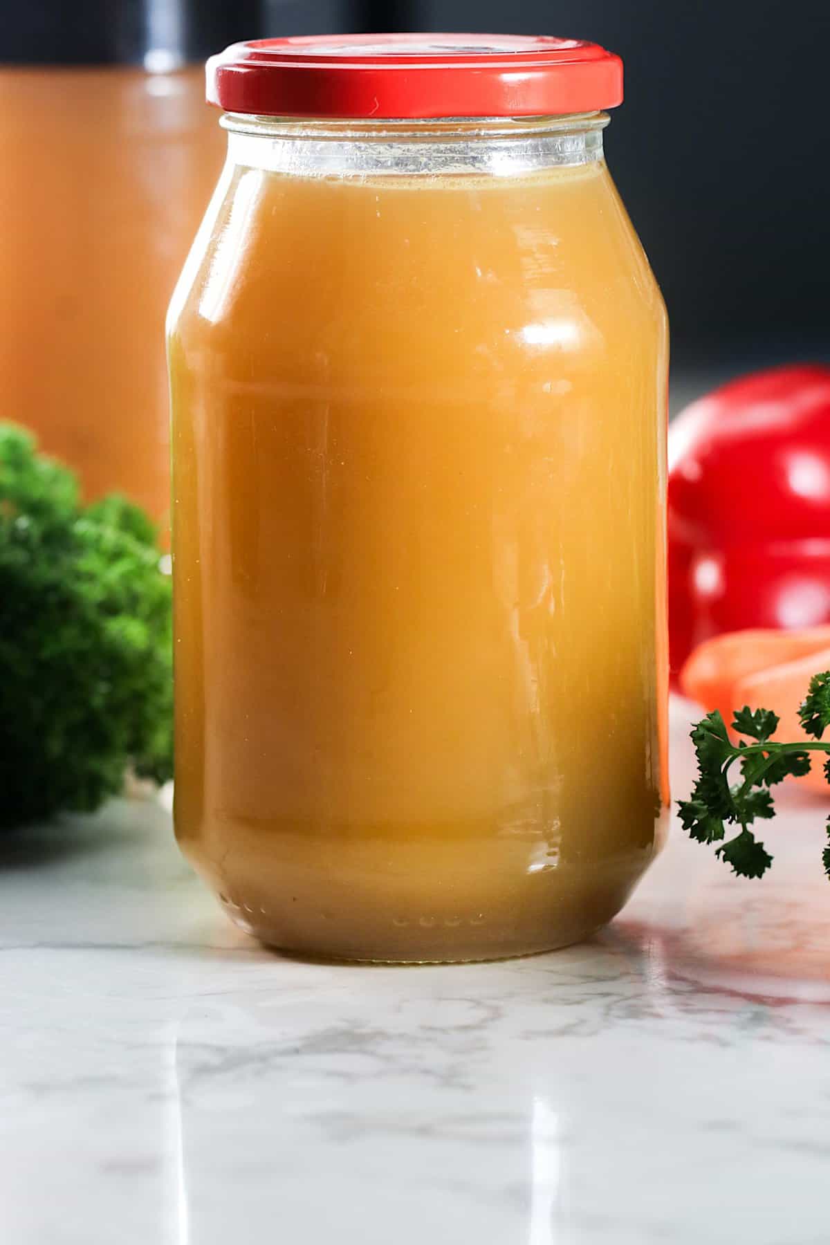 Cooled chicken stock ready to store in the fridge for easy weeknight meal prep.