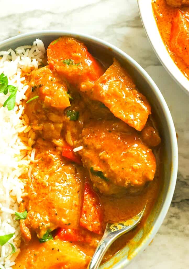 Serving up chicken and rice in the Jamaican style.