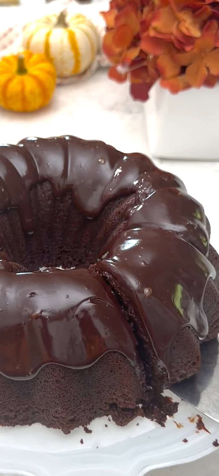 Slicing into a decadent, frosted black magic cake.