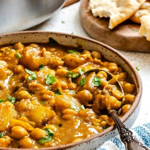 Enjoying a bowl of chickpeas spiced up with curry and coconut milk.