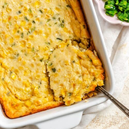 Scooping out a serving of a hearty corn pudding spiced up with jalapenos.