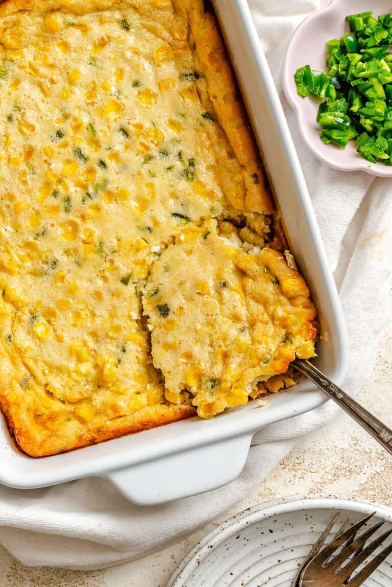 Scooping out a serving of a hearty corn pudding spiced up with jalapenos.