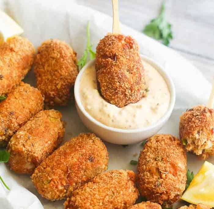 Enjoying a plate full of salmon croquettes with remoulade.
