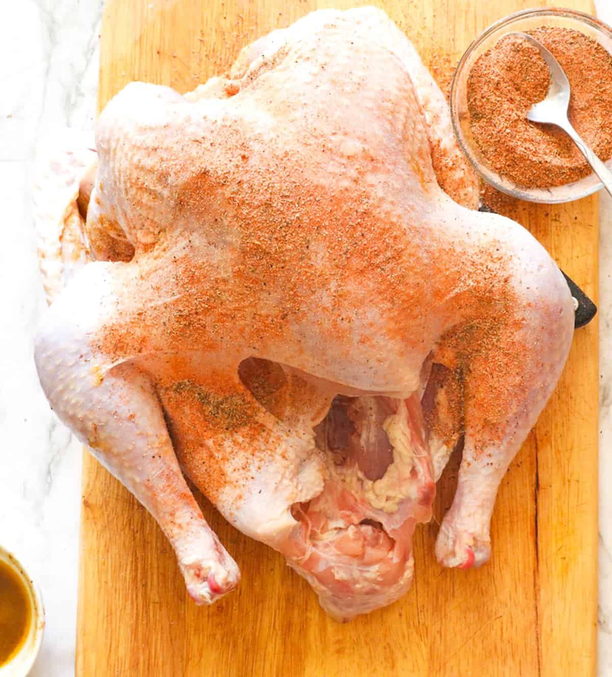 Seasoning the turkey before roasting.