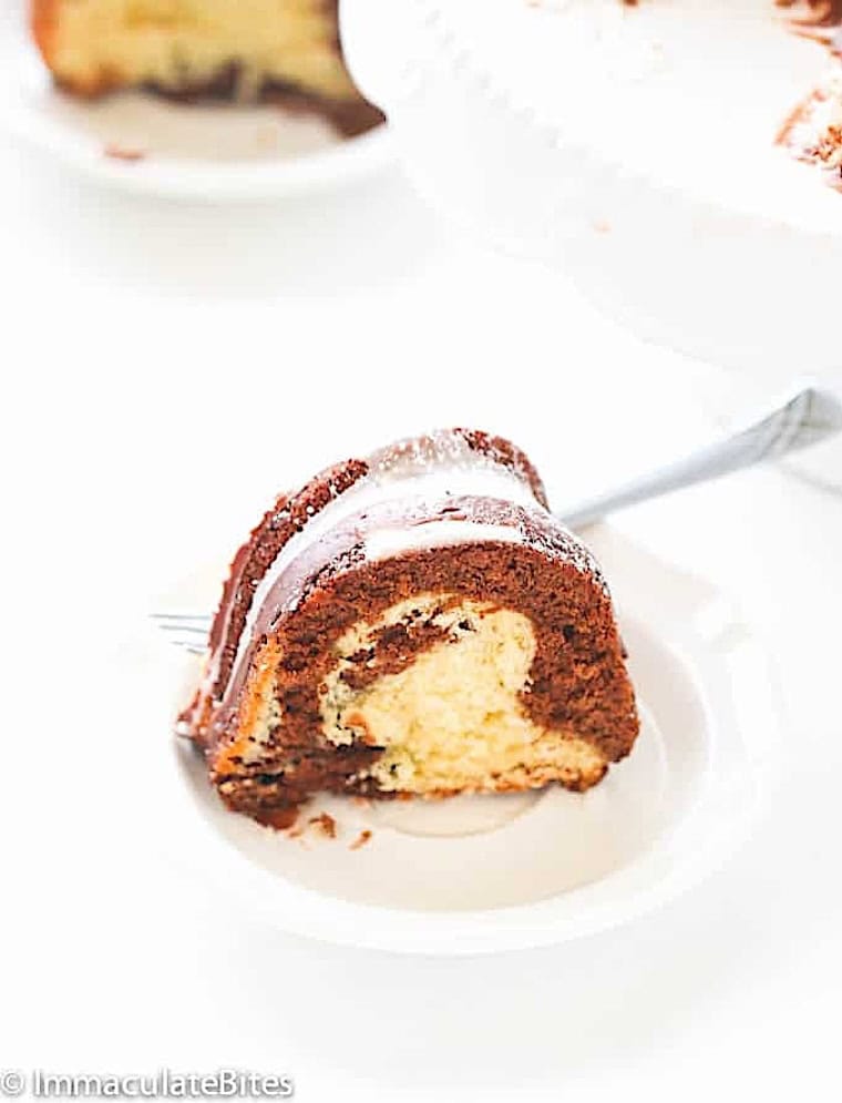 Enjoying a slice of rum-soaked marble cake with glaze.