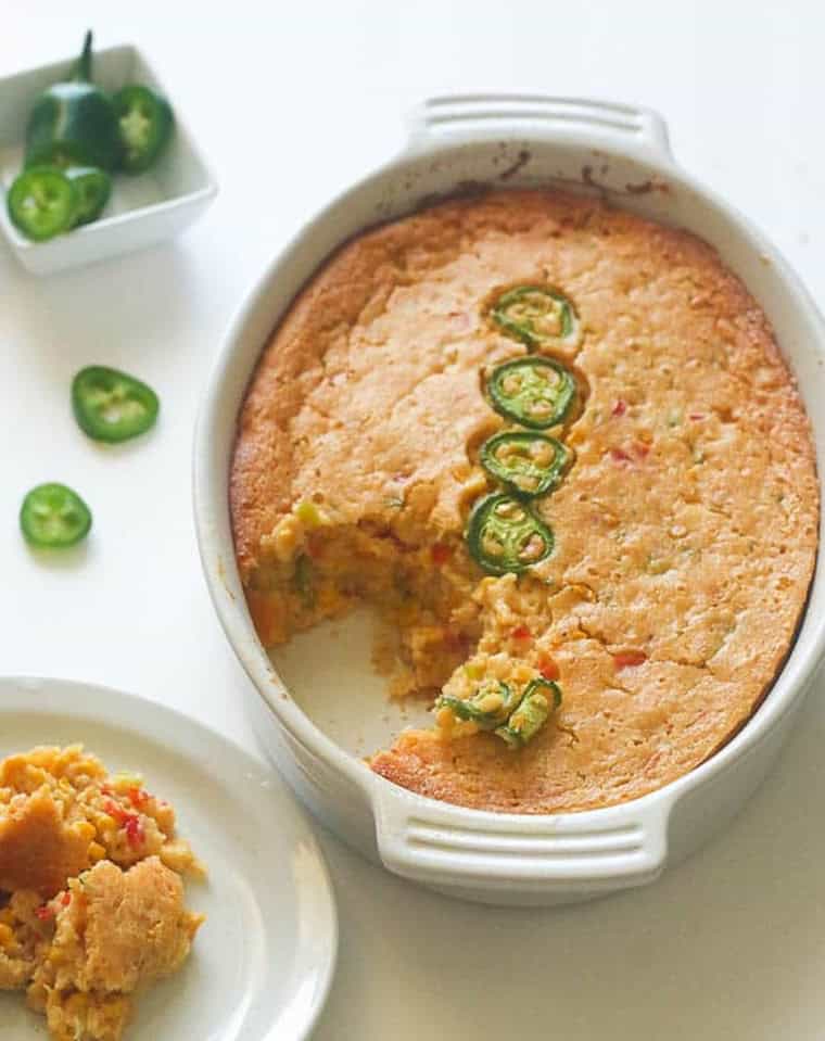 Serving up a scoop of corn casserole studded with jalapenos.