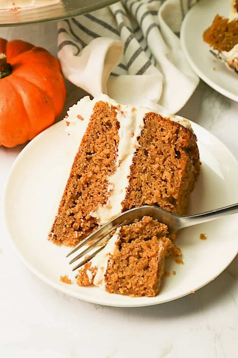 Forking into a slice of cake loaded with pumpkin and fall spices.