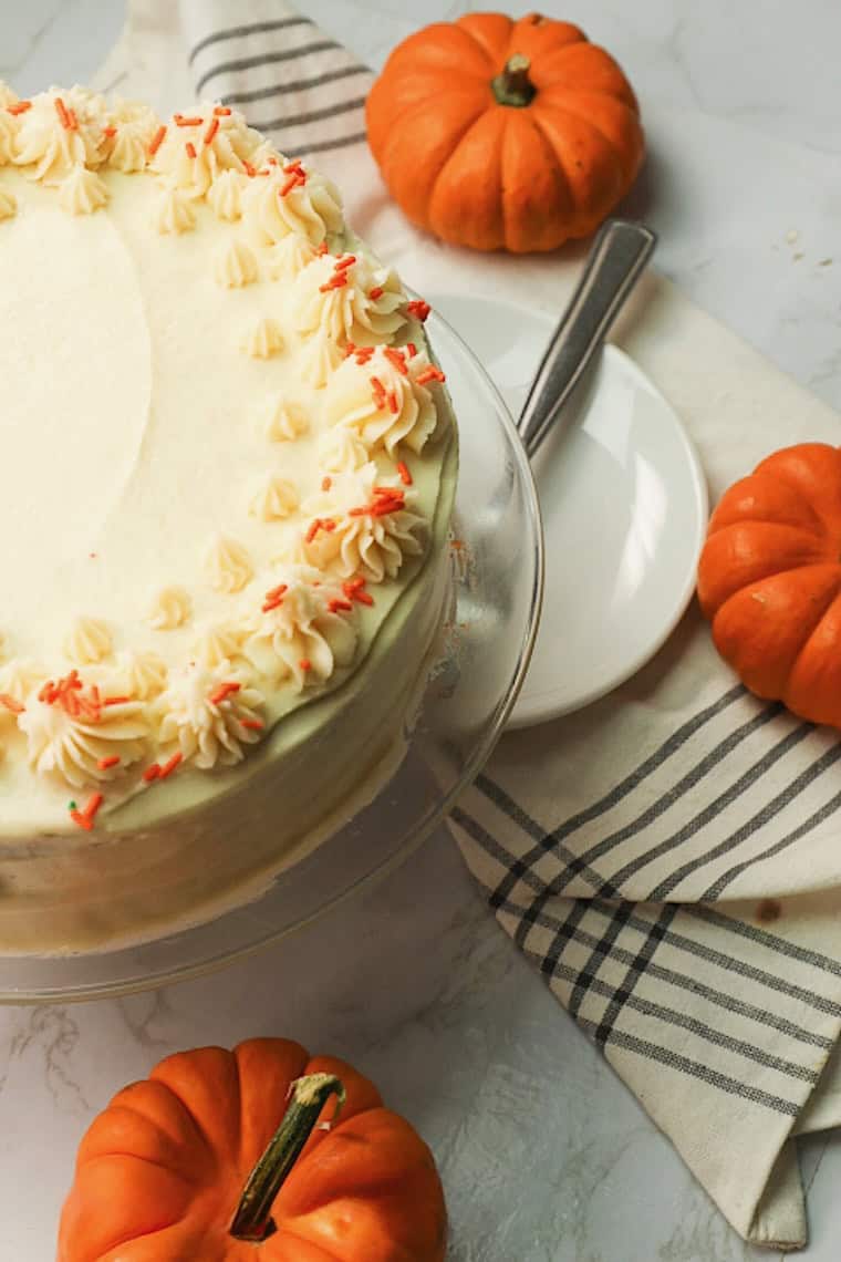 A pumpkin cake freshly frosted and decorated for a delicious holiday dessert.
