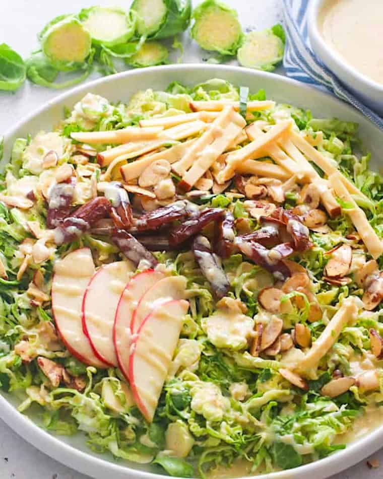 Enjoying shaved Brussels sprouts salad with apples and raisins for a lighter side dish.