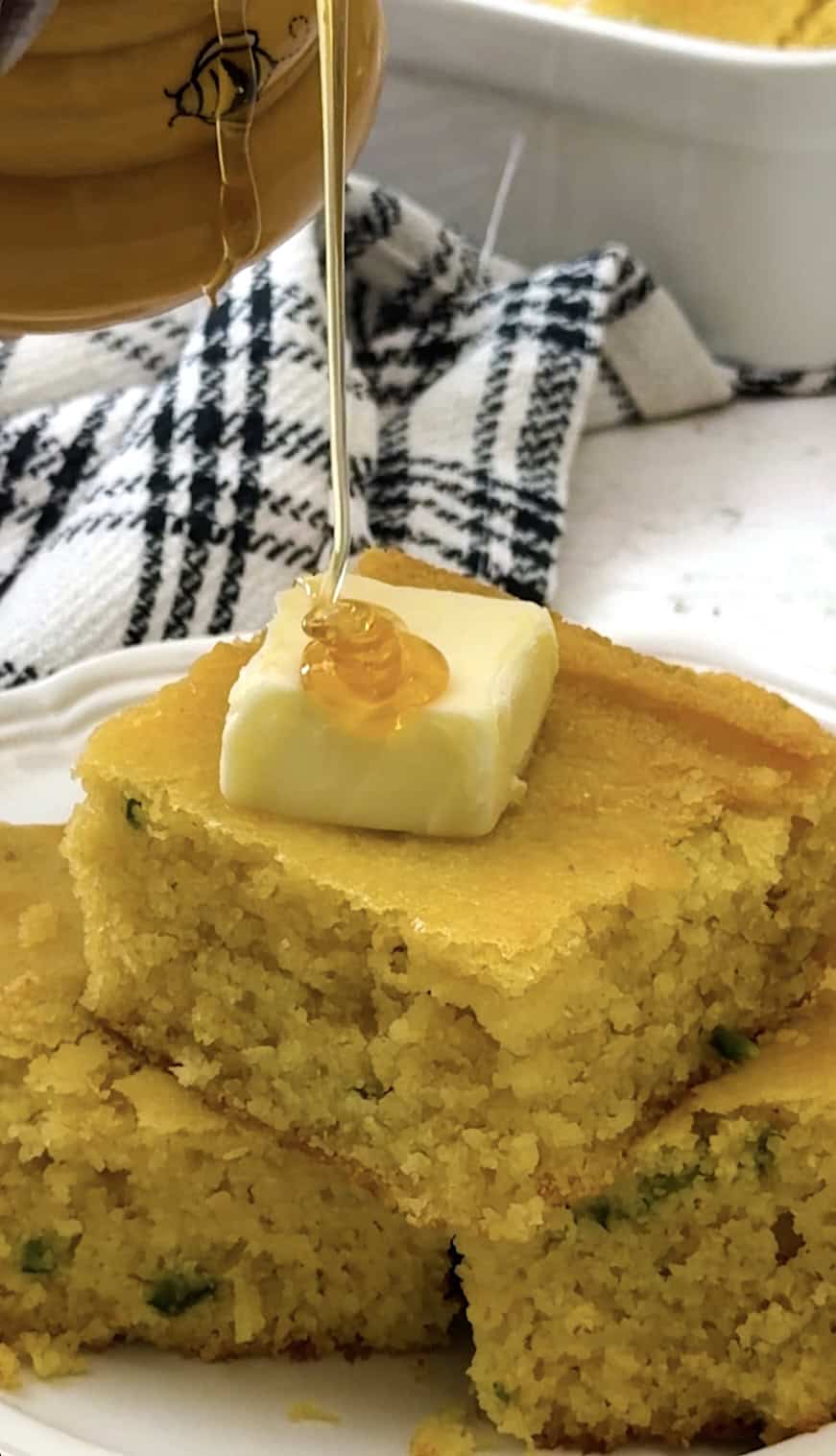 Drizzling fresh cornbread with honey.