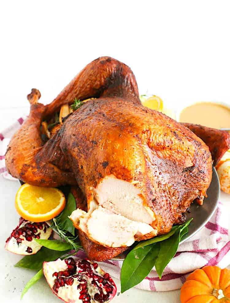 Slicing into a juicy turkey breast thanks to slow cooking in the smoker.