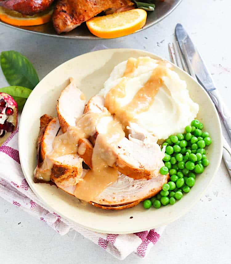 Enjoying turkey fresh from the smoker with mashed potatoes, gravy, and green peas.