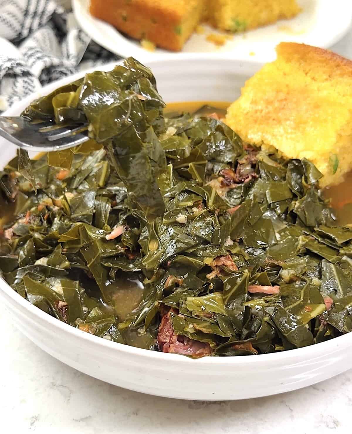 Diving into freshly cooked collard greens with cornbread on the side.