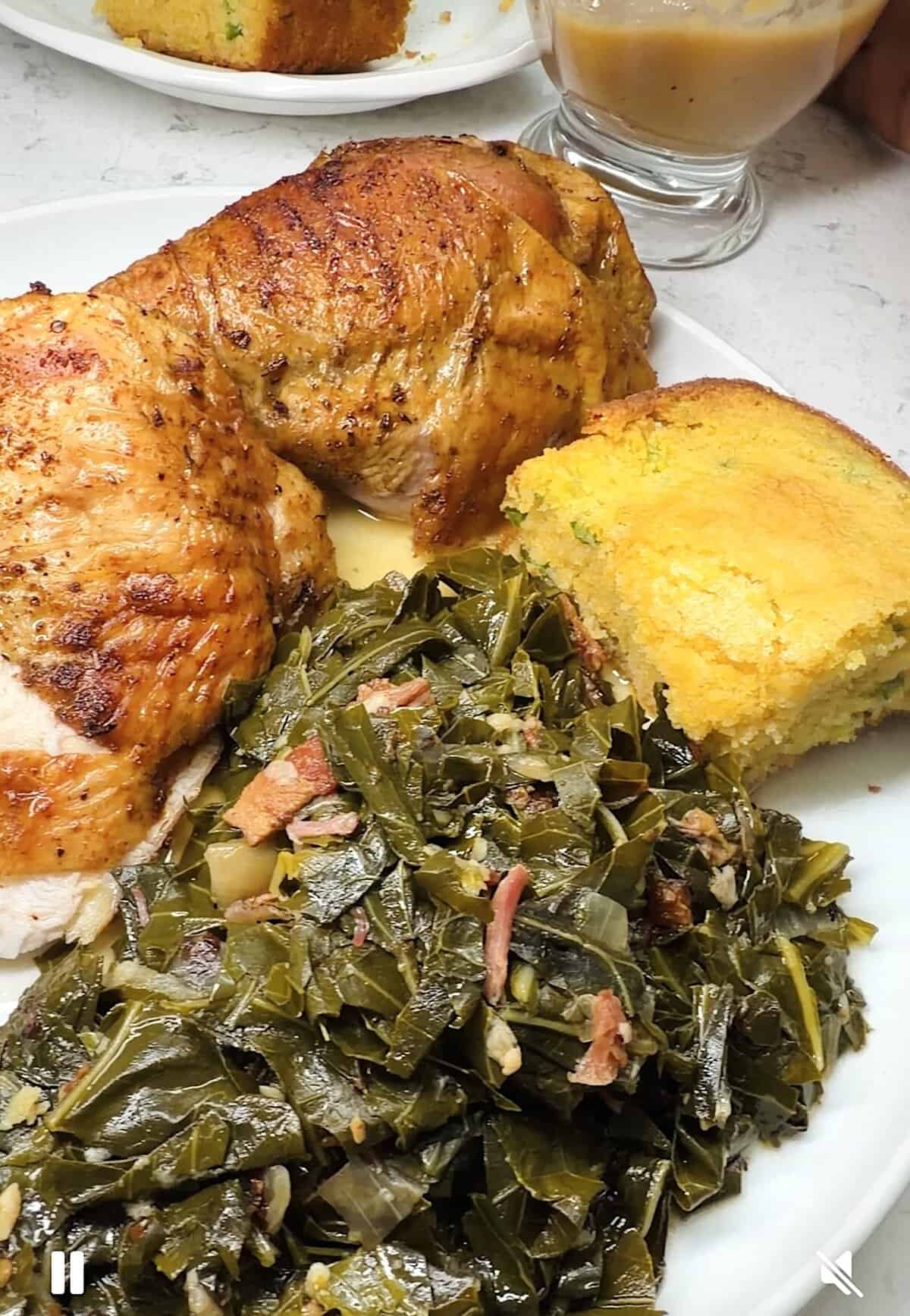 Enjoying collard greens with turkey, gravy, and cornbread.