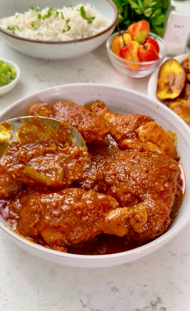 Serving up freshly made African chicken stew with coconut rice.