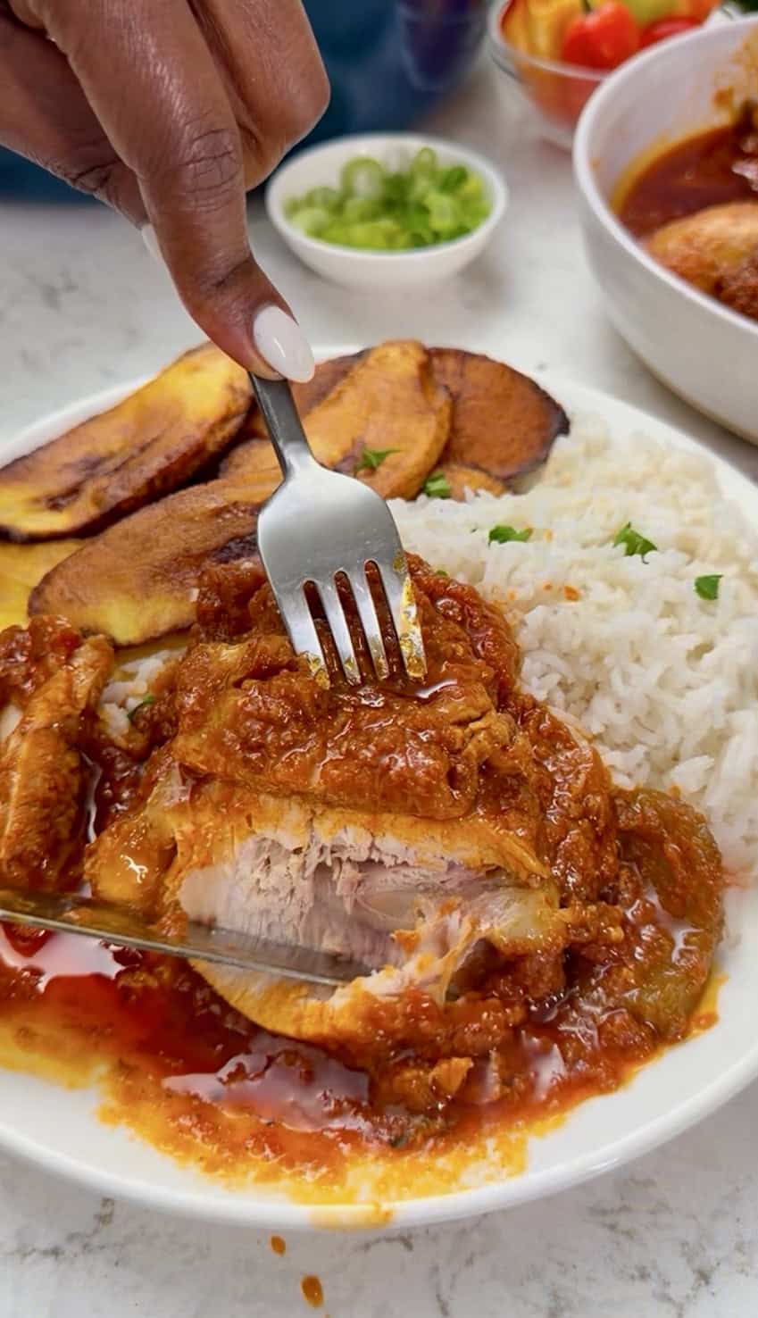 Forking into freshly served chicken stew over coconut rice.