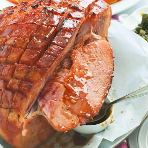 Slicing up a ham glazed with spices and brown sugar.