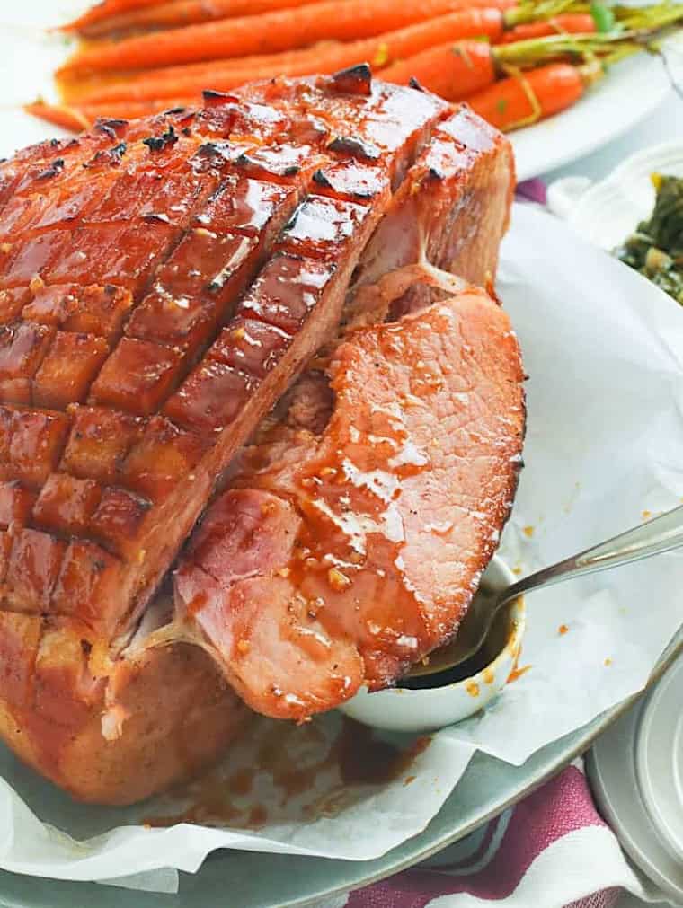 Slicing up a ham glazed with spices and brown sugar.