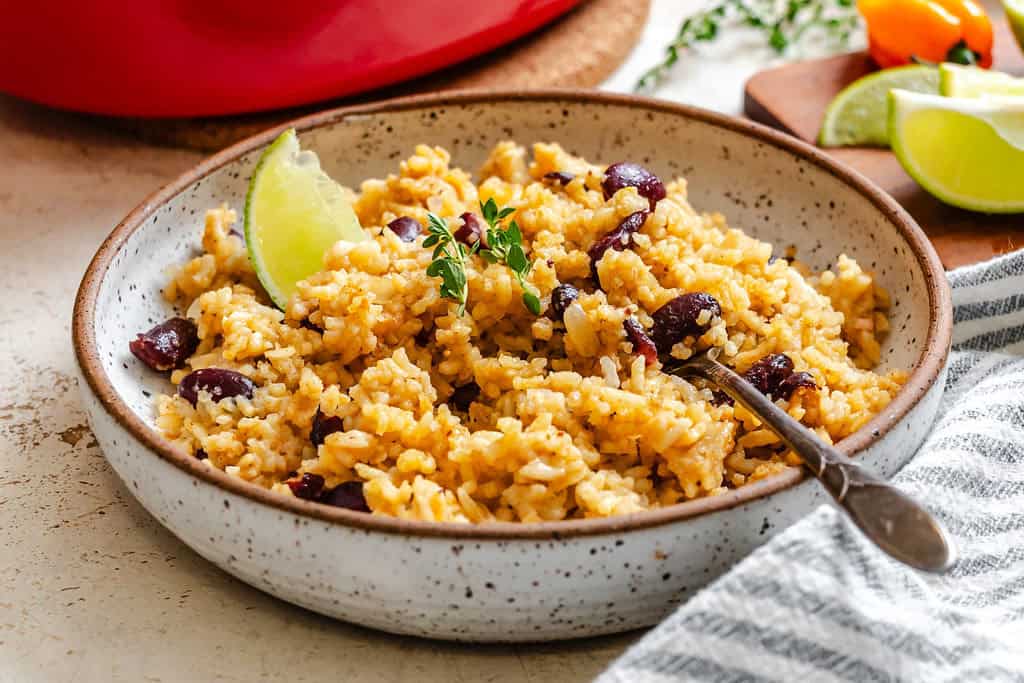 Serving up beans and rice with lemon wedges.