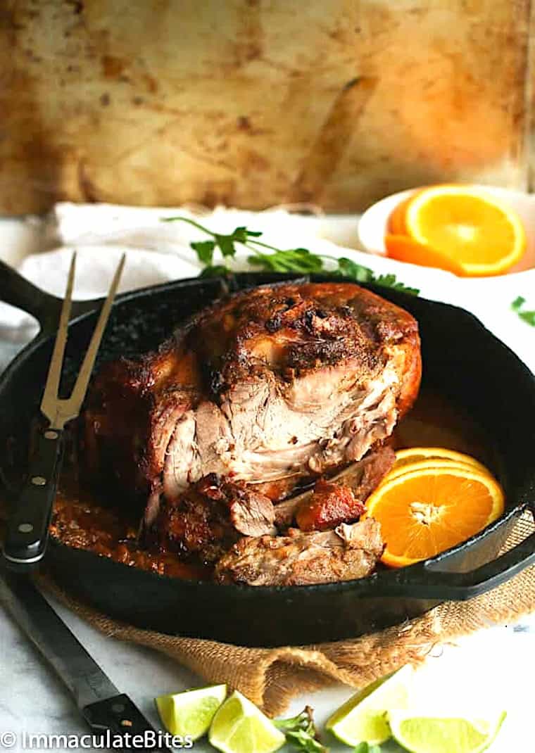 Slicing into a pork roast seasoned with tropical flavors.