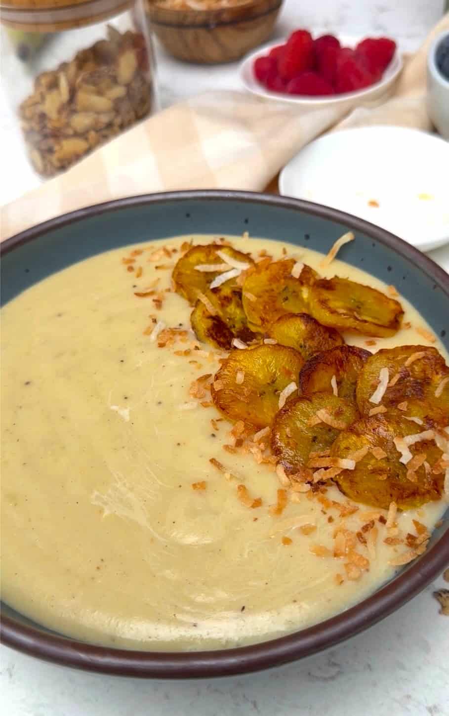Serving up freshly made Jamaican plantain porridge with fried plantains and coconut.